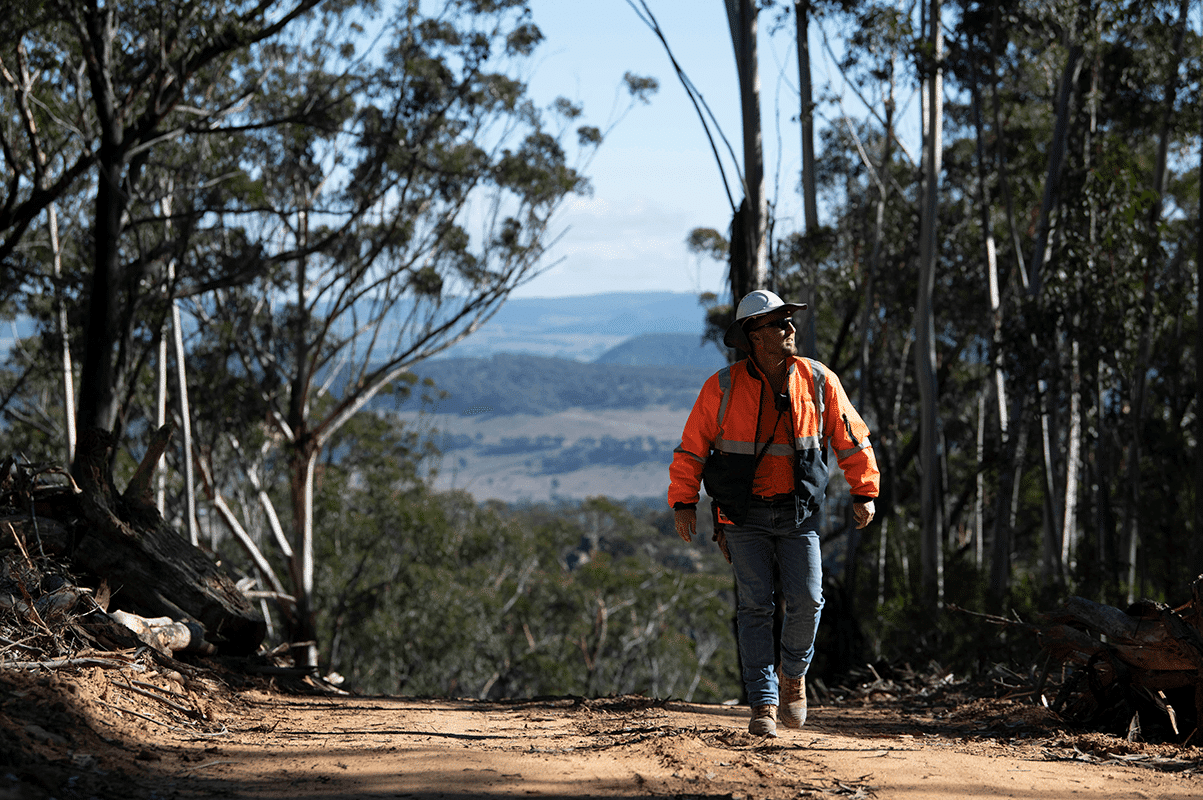 Zac Simpson walking along a fire trail at the Springvale site